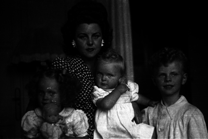 Portrait de famille en noir et blanc, une mère et 3 enfants dans un intérieur